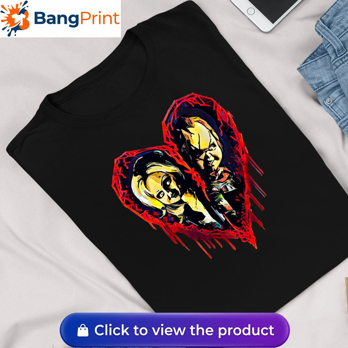 Black short-sleeve t-shirt displaying a graphic of a broken, dripping red bloody heart containing the stylized faces of horror movie characters Chucky and Tiffany.
