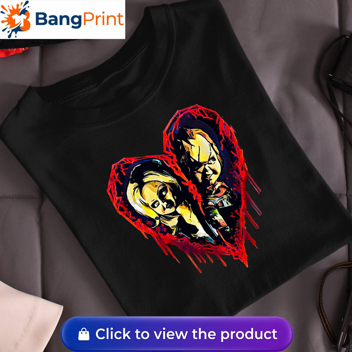 Black short-sleeve t-shirt displaying a graphic of a broken, dripping red bloody heart containing the stylized faces of horror movie characters Chucky and Tiffany.