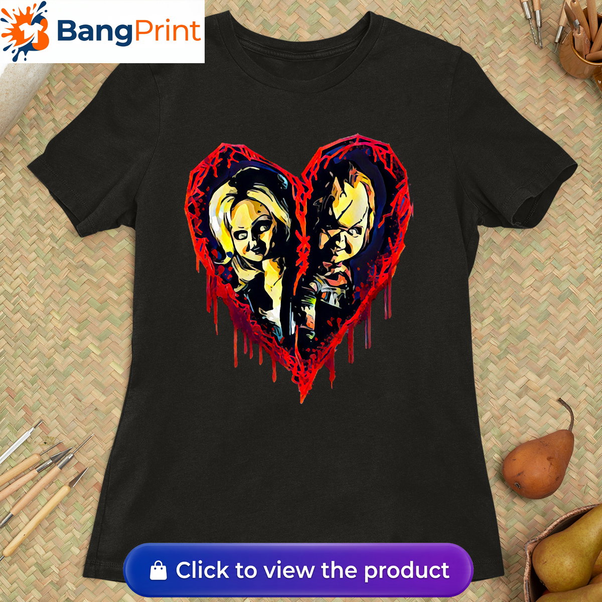 Black short-sleeve t-shirt displaying a graphic of a broken, dripping red bloody heart containing the stylized faces of horror movie characters Chucky and Tiffany.